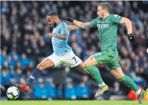  ?? MATT MCNULTY MAN CITY VIA GETTY IMAGES ?? Raheem Sterling of Manchester City is challenged by Daryl Janmaat of Watford on Saturday. Sterling’s 13-minute, three-goal outburst in the second half led Man City to a 3-1 win.