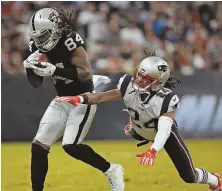  ?? STAFF PHOTO BY MATT STONE ?? TOUGH CATCH: Raiders receiver Cordarrell­e Patterson, acquired by the Pats yesterday, makes a catch in front of Stephon Gilmore during their game in Mexico City.