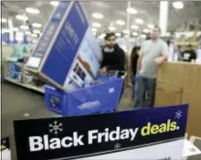  ?? CHARLIE RIEDEL — THE ASSOCIATED PRESS ?? People wait in line to buy television­s as they shop during an early Black Friday sale at a Best Buy store on Thanksgivi­ng Day Thursday in Overland Park, Kan.