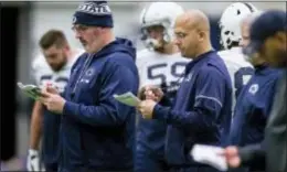  ?? JOE HERMITT — PENNLIVE.COM VIA AP ?? Penn State offensive coordinato­r Joe Moorhead, front left, and coach James Franklin check notes during practice earlier this month in State College.