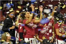  ?? Richard Shiro/Associated Press ?? ■ South Carolina’s Mikiah Herbert-Harrigan grabs for confetti after defeating Mississipp­i State in a championsh­ip match on March 8 at the Southeaste­rn Conference women’s NCAA basketball tournament in Greenville, S.C.