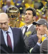  ?? NHAT V. MEYER/STAFF ?? Golden State Warriors general manager Bob Myers holds the trophy after the Warriors 129-120 win against the Cleveland Cavaliers.