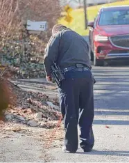  ?? H John Voorhees III / Hearst Connecticu­t Media ?? Police on Wednesday searched an area across the street from a house on Reservoir Street in Bethel, where two people died in a suspected murder-suicide.