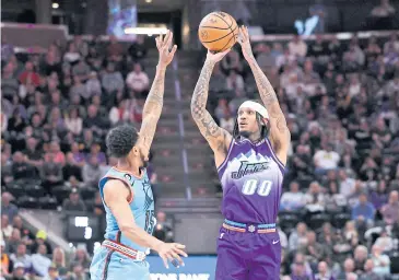  ?? USA TODAY SPORTS ?? Jazz guard Jordan Clarkson shoots against Suns guard Cameron Payne in the first quarter at Vivint Arena.