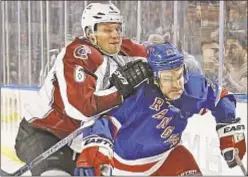  ?? GETTY ?? Avs defenseman Erik Johnson (l.) is all over Rangers’ Dan Boyle as listless Blueshirts drop game on Thursday at Garden.