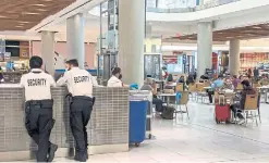  ?? KELSEY WILSON TORONTO STAR ?? Cadillac Fairview spokespers­on Anna Ng says security teams, like these personnel at the Toronto Eaton Centre, “will be stationed at the entrance of food court seating areas to validate visitors’ vaccinatio­n passports.”