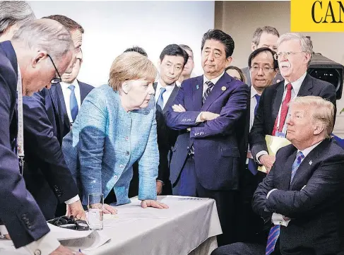  ?? JESCO DENZEL/BUNDESREGI­ERUNG/AFP/GETTY IMAGES ?? This photo, taken by the German government photograph­er, of U.S. President Donald Trump talking with German Chancellor Angela Merkel while surrounded by other leaders at the G7 Summit in Charlevoix, Que., went viral on social media on the weekend.
