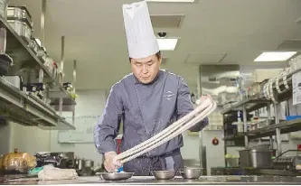  ??  ?? Noodle master: Jing Ting chef de cuisine Yang Chen Fei can prepare a bowl of delightful hand-pulled noodles in just two minutes.