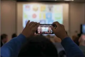  ?? RICK KAUFFMAN — DIGITAL FIRST MEDIA ?? A member of the audience snaps a picture of dozens of social media logos that were part of a quiz to the audience of a Cyber Security Seminar at Neumann University, produced by guest speaker Paul Sanfrances­co, the director of technology at Owen J....