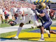  ?? ?? Houston’s Sam Brown makes a touchdown catch in front of Navy cornerback Mbiti Williams Jr.