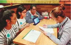  ?? Courtesy: GEMS Modern Academy, Dubai ?? From left: Students Bennet Jude, Sumedha Mohanty and Mihira Anand discuss the #reduceplas­ticstraw’ campaign with an employee of Chili’s restaurant at Dubai Mall.