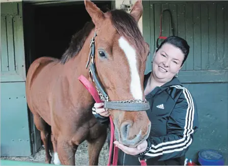  ?? KRIS DUBE SPECIAL TO THE ST. CATHARINES STANDARD ?? Trainer Julie Robillard-Mathes, shown with Tuition, one of the horses in her stable, is look forward to the upcoming thoroughbr­ed racing season at Fort Erie Race Track.