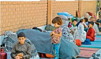  ?? —
AFP ?? Internally displaced Afghan families, who fled from the northern province due to battle between Taliban and Afghan security forces, sit in the courtyard of the Wazir Akbar Khan mosque in Kabul on Friday.