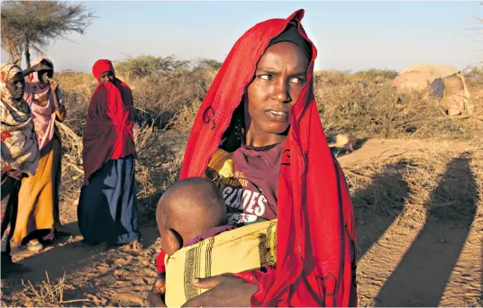  ??  ?? A starving Somali family, and inset left, 19-year-old Hinda Cadare