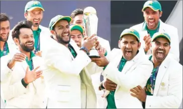  ??  ?? Pakistan captain Sarfraz Ahmed (third right) and his players celebrate with the ICC Champions Trophy after beating India in the final at The Oval in London on Sunday.