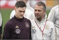  ?? ARNE DEDERT — DPA VIA AP ?? Germany’s national coach Hansi Flick, right, talks to Florian Wirtz during the national team’s training session at the DFB campus prior to a match Wednesday against Peru, in Frankfurt, Germany.