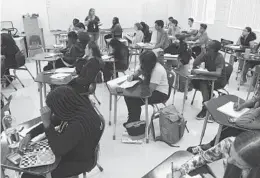  ?? TAIMY ALVAREZ/SUN SENTINEL PHOTOS ?? Atlantic High geometry teacher Vera Obaido teaches students in Delray Beach on Friday. There are more than 3,500 public school teaching vacancies in Florida this year.