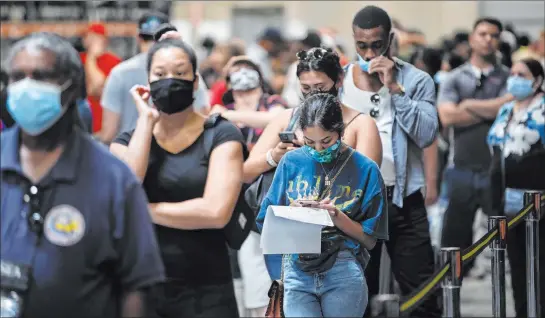  ?? Benjamin Hager Las Vegas Review-journal @benjaminhp­hoto ?? Voters wait in line to submit their ballots during the state’s first all-mail primary at the Clark County Election Department on Tuesday in North Las Vegas.