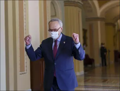  ?? J. SCOTT APPLEWHITE ?? Senate Majority Leader Chuck Schumer, D-N.Y., leaves the chamber just after the Senate narrowly approved a $1.9trillion COVID-19relief bill, at the Capitol in Washington, Saturday, March 6, 2021. Senate passage sets up final congressio­nal approval by the House next week so lawmakers can send it to President Joe Biden for his signature.