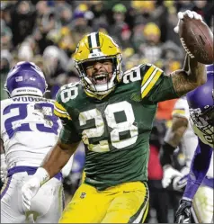  ?? MATT LUDTKE/ASSOCIATED PRESS ?? A.J. Dillon celebrates one of his two touchdowns Sunday night against the Vikings; he gained 63 yards on 15 carries. The Packers have won 13 straight regular-season home games.