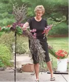  ?? JOCELYN WILLIAMS/AKRON BEACON JOURNAL FILE PHOTO ?? Akron Garden Club member Tasha Tobin works on a floral arrangemen­t inspired by a Jim Dine painting in 2001.