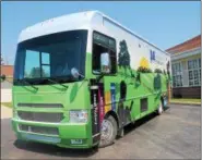  ?? KRISTI GARABRANDT — THE NEWS-HERALD FILE ?? Geauga County Public Library’s Bookmobile sits behind the Middlefiel­d branch ready to make its first delivery route on April 30. The 35 foot bus carries over 4,000 materials.