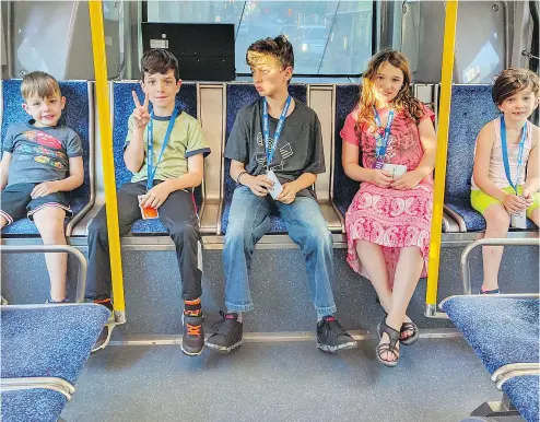  ?? ADRIAN CROOK / THE CANADIAN PRESS ?? Adrian Crook’s children ride a bus in Vancouver. Crook says the Children’s Ministry barred him from letting his children ride the bus alone and the case has led to debate about when parents should be able to leave kids unsupervis­ed.