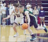  ?? Graham Thomas/Siloam Sunday ?? Alma senior Cejay Mann, right, handles the ball as Siloam Springs sophomore Carter Winesburg defends during Tuesday’s game at Panther Activity Center. The Airedales defeated the Panthers 50-49.