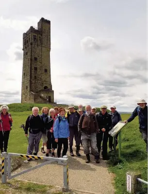  ??  ?? ●● Destinatio­n in sight with the Victoria Tower just visible on the horizon, above left, and the group gathers below the tower, above