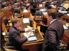  ?? MELINDA DESLATTE — THE ASSOCIATED PRESS FILE ?? Rep. Jean-Paul Coussan, R-Lafayette, left, speaks with Rep. Tanner Magee, R-Houma, on the opening day of the special legislativ­e session in Baton Rouge, La.