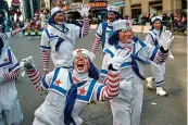  ?? AP Photo/Andres Kudacki ?? ■ Clowns wave to the crowd along Sixth Avenue during the Macy’s Thanksgivi­ng Day Parade in New York.