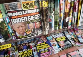  ?? AP FILE PHOTO/MARY ALTAFFER ?? A 2017 issue of the National Enquirer featuring President Donald Trump on its cover is displayed on a newsstand in a store in New York.