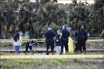  ?? ANDRES LEIVA / THE PALM BEACH POST ?? Boynton Beach authoritie­s work at the scene of Wednesday’s accident near Ocean Avenue. City police, in a statement, urged the public “to take extra caution when approachin­g railroad crossings.”