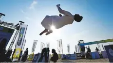  ?? Ahmed Ramzan/Gulf News ?? ■ Zayed Al Nuaimi does a backflip at the Dubai Fitness Challenge at Kite Beach.