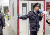  ?? AFP ?? Police officers guard as students evacuate a building of the Perm university campus in Perm following a shooting.—