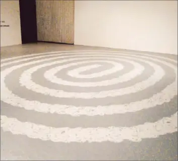  ?? Christophe­r Knight Los Angeles Times ?? RICHARD LONG marks a spiral path as long as the distance from base to peak of a prehistori­c earth-mound.