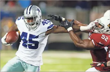  ??  ?? Dallas’ Rod Smith (left) holds off Arizona’s Zaviar Gooden on Thursday during the Pro Football Hall of Fame game.