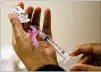  ?? AP 2018 ?? It’s too soon to know if the U.S. is in for a third miserable flu season in a row, but health officials say not to delay vaccinatio­n.