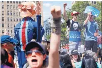  ?? JOHN MINCHILLO/ASSOCIATED PRESS ?? Supporters of Bernie Sanders march during a protest in downtown Philadelph­ia on Sunday in the first major protests of the Democratic National Convention, which starts today.
