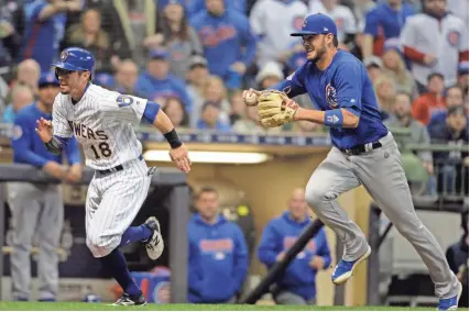  ?? ASSOCIATED PRESS ?? Eric Sogard is chased by Cubs third baseman Kris Bryant during a rundown between third and home during the sixth inning Friday night. The game was tied, 4-4, after eight innings and ended too late for this edition.