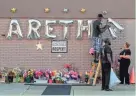  ?? AGENCY EUROPEAN PRESS ?? People work on a memorial for singer Aretha Franklin outside the New Bethel Baptist Church in Detroit Thursday. The music legend’s funeral is set for 9 a.m. Friday.