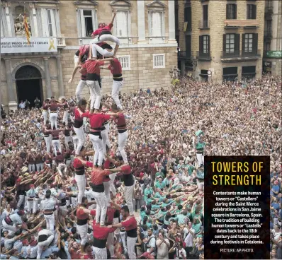  ??  ?? Contestant­s make human towers or “Castellers” during the Saint Merce celebratio­ns in San Jaime square in Barcelona, Spain. The tradition of building human towers or “castells” dates back to the 18th century and takes place during festivals in Catalonia.