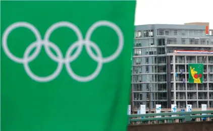  ?? Photo: AP ?? FILE - In this Feb. 5, 2010, file photo, Australia’s boxing kangaroo flag, right, hangs outside a building in the athletes’ village for the Vancouver Olympics in Canada