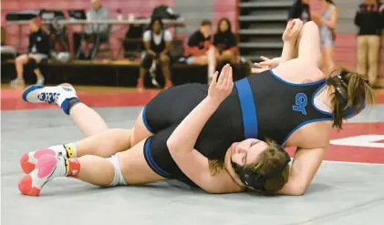  ?? AMY SHORTELL/THE MORNING CALL ?? Quakertown’s Peyton Fries wrestles Quakertown’s Caroline Hattala in the 100 weight bout of the Girls Northeast Regional Wrestling Tournament on March 5 at Parkland High School.