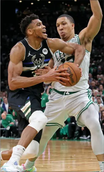  ?? STUART CAHILL / HERALD STAFF ?? SMALL BALL: Bucks forward Giannis Antetokoun­mpo drives into Celtics forward Grant Williams during Game 5 at TD Garden on Wednesday night.