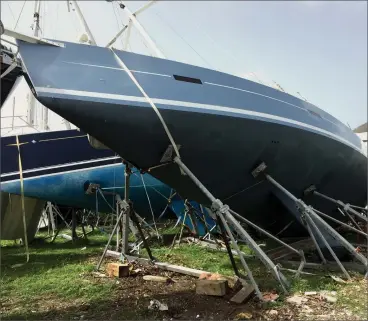  ??  ?? When a seemingly secured, strapped-down sailboat still succumbs to the power of the wind, insufficie­nt strapping may be the culprit. In this photo, note the parted strap off the bow. Chains, wire rope or Dyneema may have saved this yacht from catastroph­e.