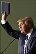  ??  ?? Angry: Donald Trump holds up the Bible his mother gave him