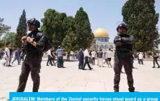  ?? — AFP ?? JERUSALEM: Members of the Zionist security forces stand guard as a group of Orthodox Jews enters the Al-Aqsa mosque compound yesterday.