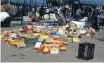  ??  ?? Boxes and goods lay scattered after foreign national traders were attacked on Sunday.