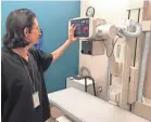  ?? THE ARIZONA REPUBLIC ?? David Whipple tests an X-ray machine at the USCareWays urgent care, set to open Friday. It will be open 8 a.m. to 8 p.m. daily.